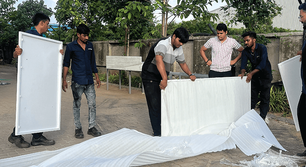 Offside fabrication team assembling large metal panel — onsite installation, Surat Gujarat